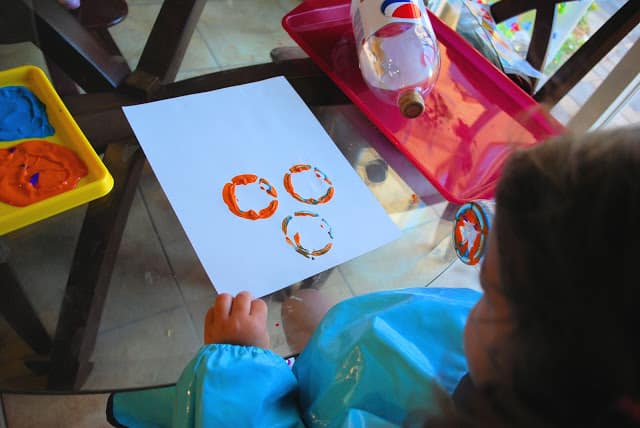 making bottle print flowers with paint.