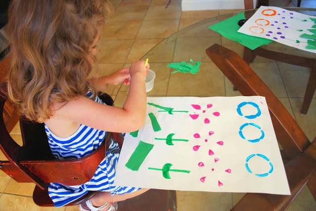 kid making bottle print flowers