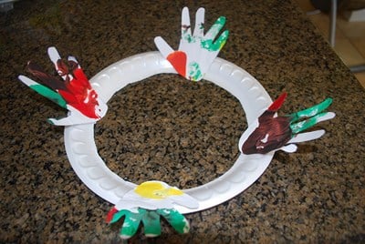 gluing paper hands to a wreath