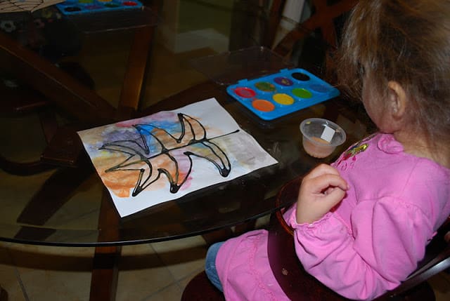 child painting leaf picture