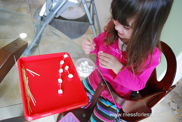 child making marshmallow sculptures