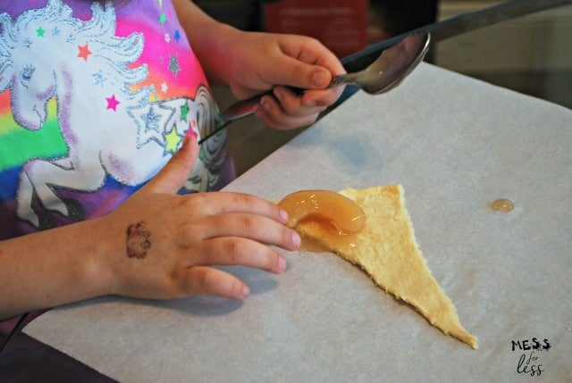 child making apple crescents