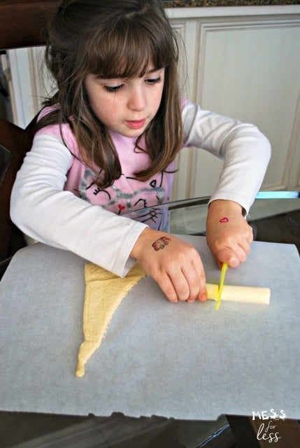 child cutting string cheese