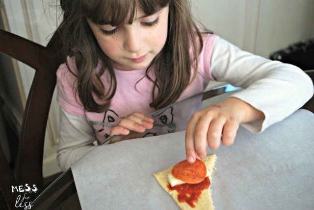 child making pepperoni pizza crescents