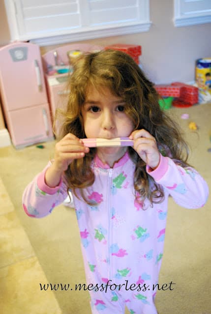 child playing homemade harmonica