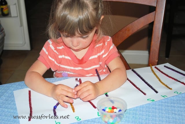 child playing with pipe cleaners