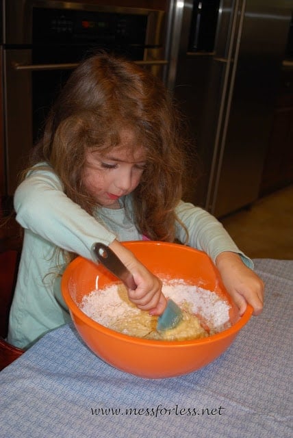 child mixing flour