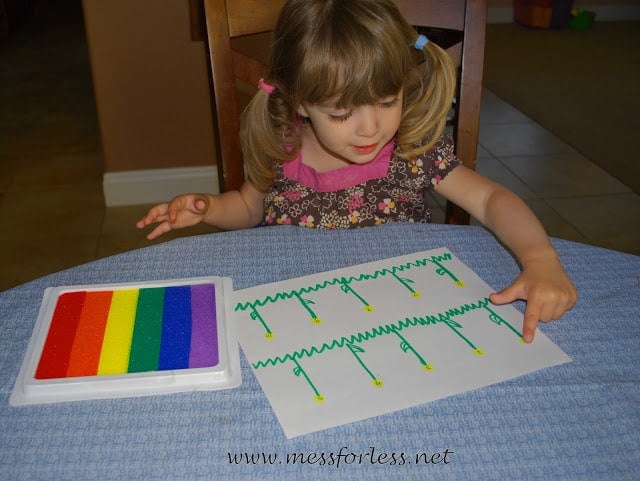 child stamping finger prints