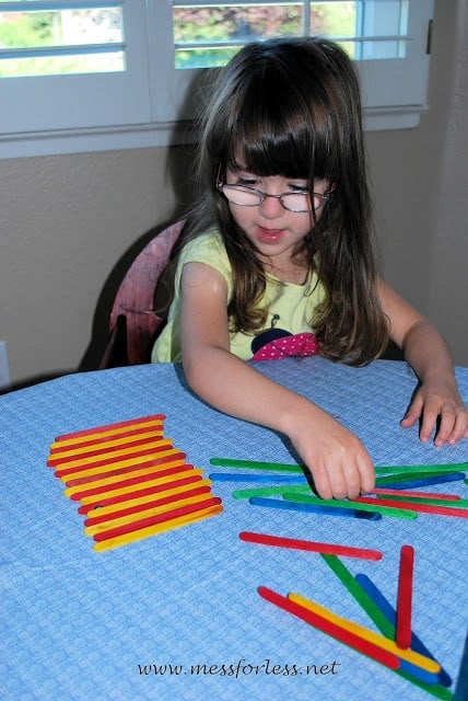 kids making popsicle stick patterns