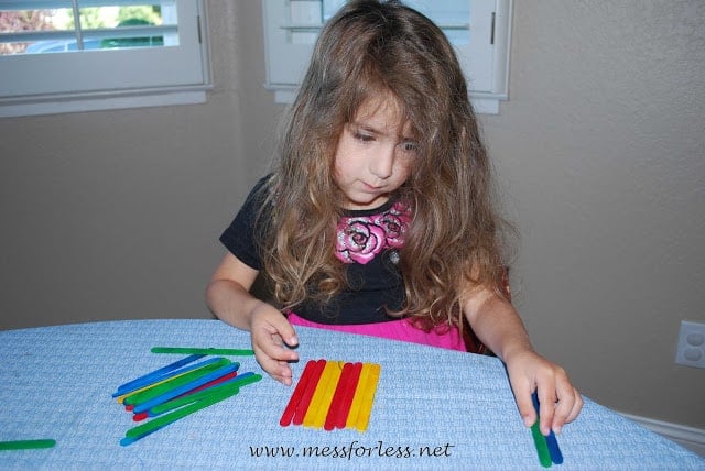 kids making popsicle stick patterns