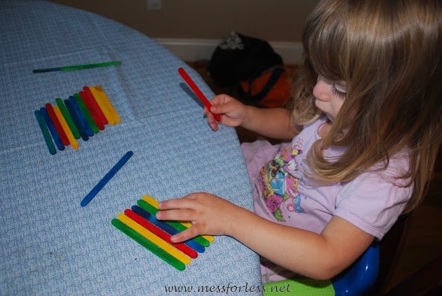 kids making popsicle stick patterns