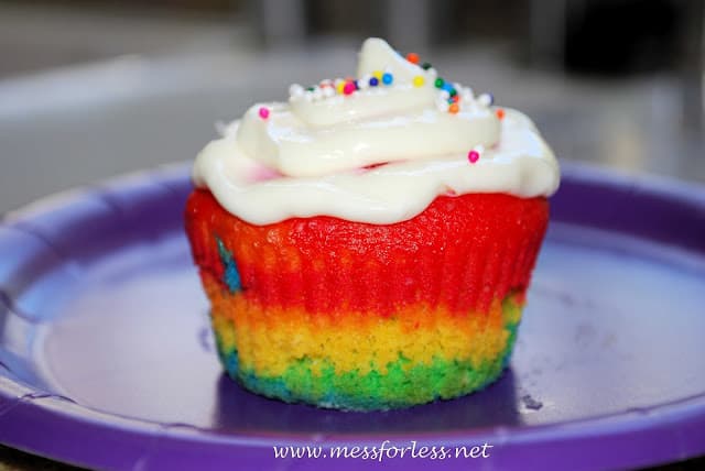 rainbow cupcake with frosting on purple plate