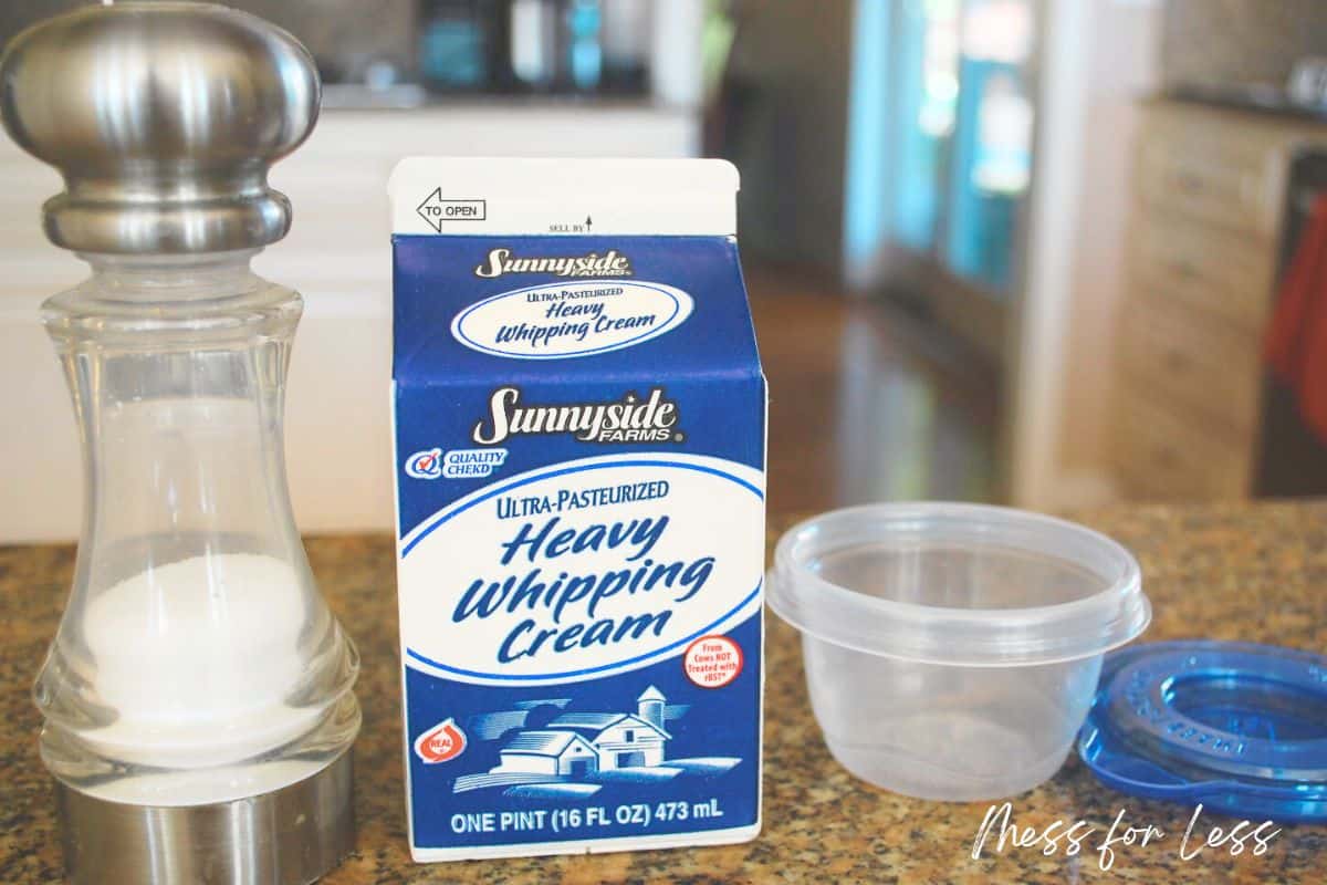 salt, cream and container on granite counter