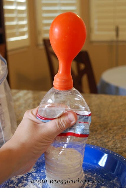 water bottle filled with flour with a balloon on top