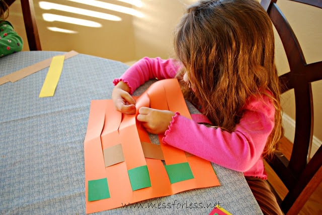 child weaving paper placemats