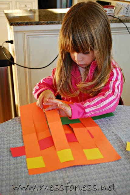 child making woven paper placemats