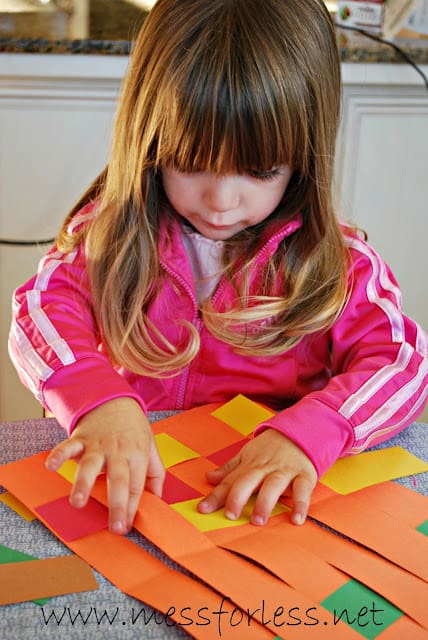 child making a woven paper placemat