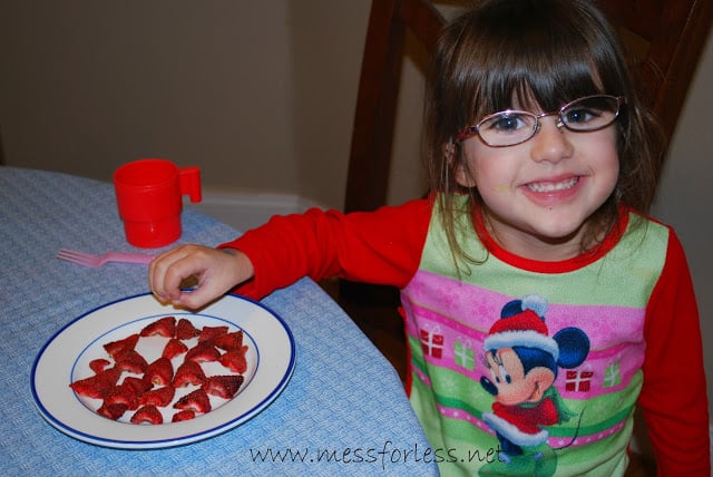 child with dried strawberries