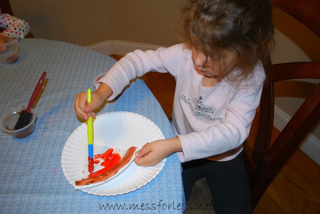 child painting a plate