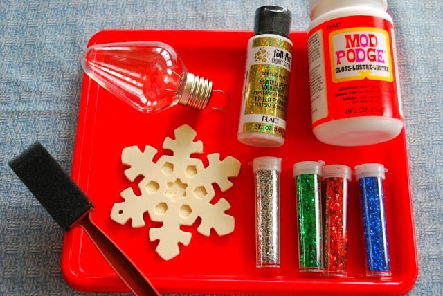 mod podge, glitter and ornaments on a tray