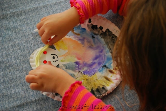 child making paper plate angel