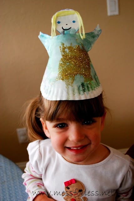 child with angel hat