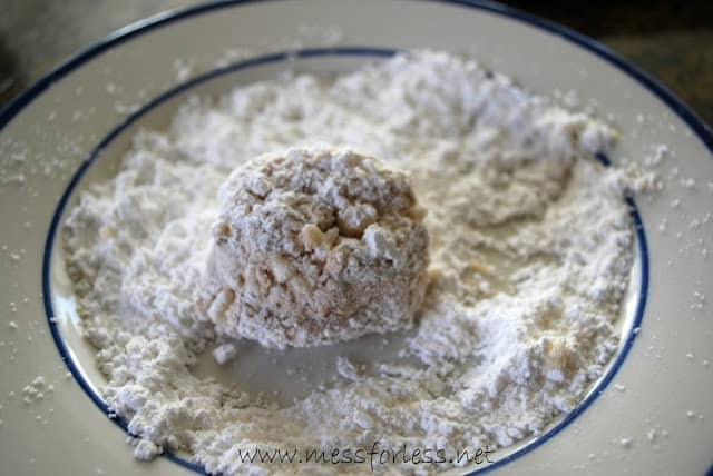 rolling chocolate snowballs in powdered sugar