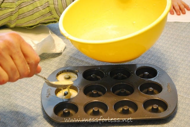 pouring batter in a donut pan