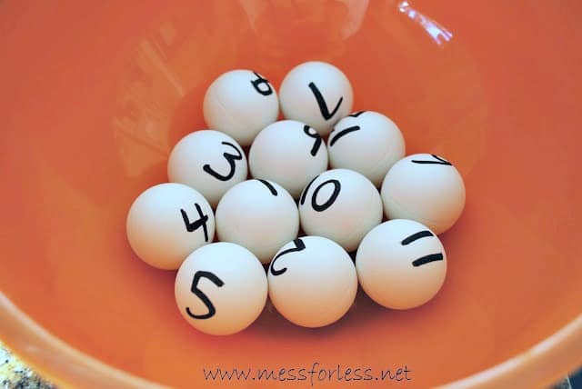 ping pong balls with numbers on them in a bowl