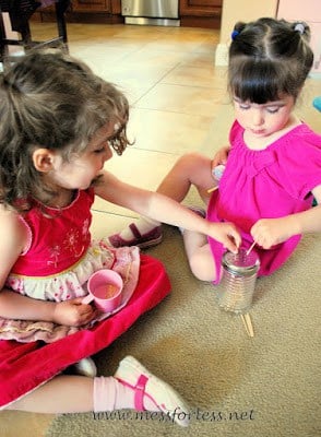 children placing tooth picks in shaker