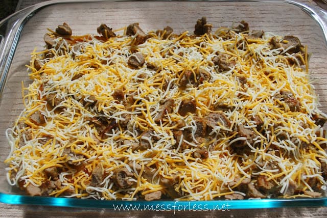 sausage and shredded cheese in pan