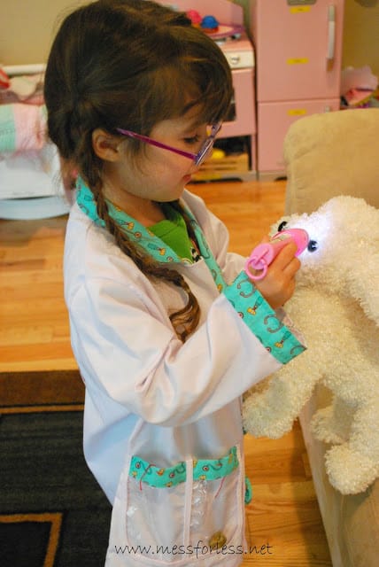 child examining stuffed animal