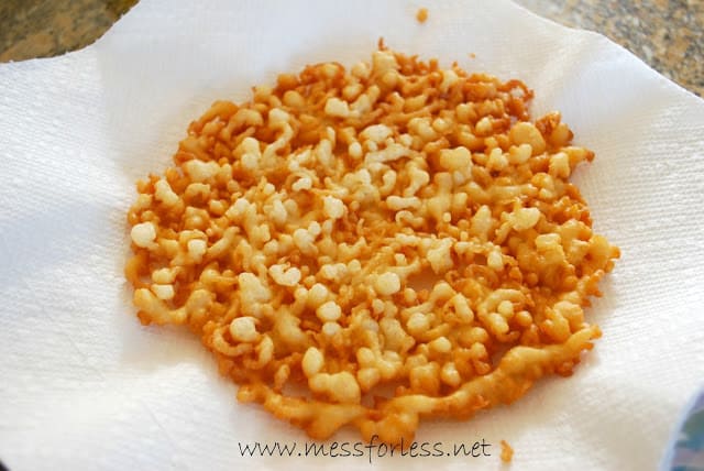 homemade funnel cake draining on napkin