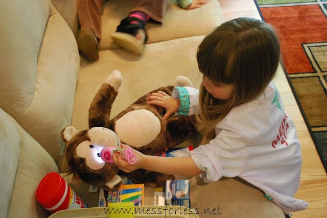 child examining a stuffed animal monkey