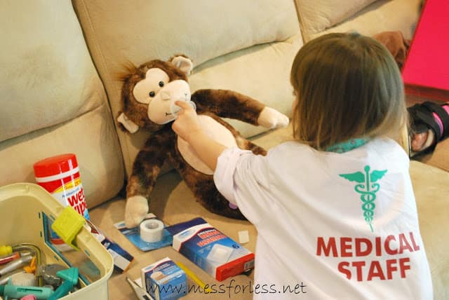 child playing with stuffed monkey