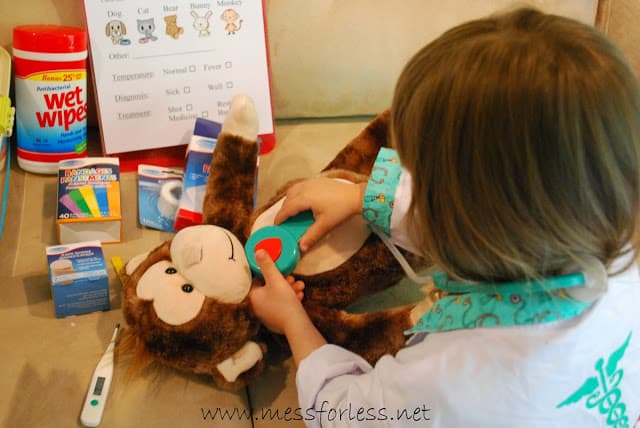 child giving stuffed animal medical exam