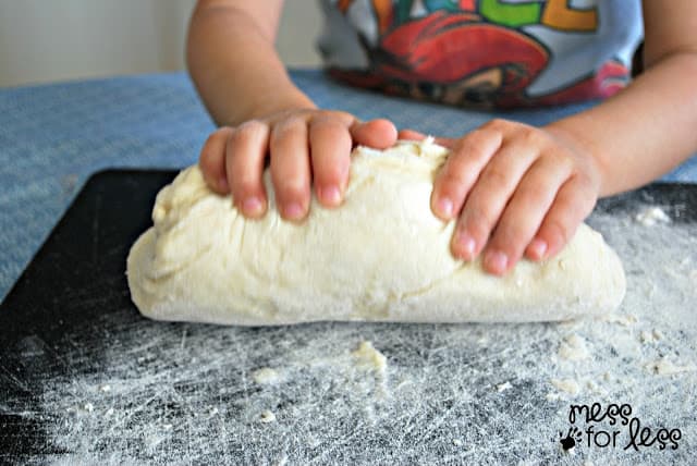 child kneading dough