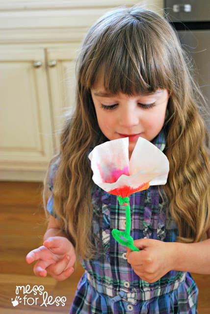 child holding a coffee filter flower