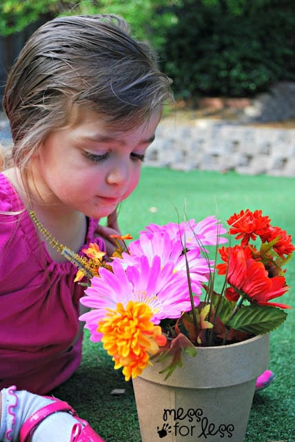 child smelling flowers