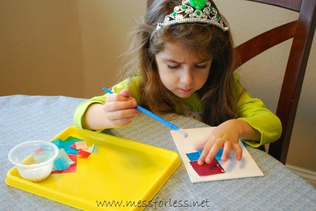 child making a tissue paper square collage