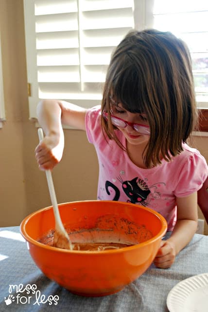 child stirring a bowl