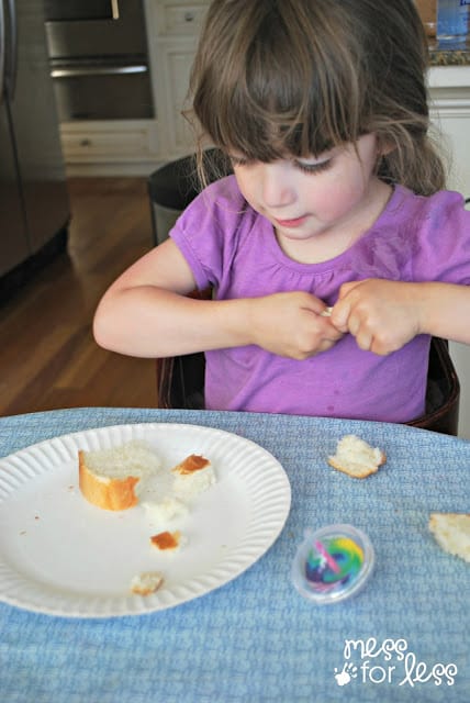 child tearing bread