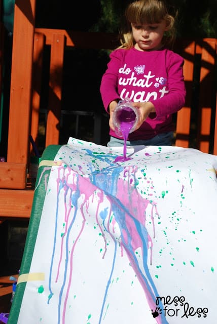 Use a slide or easel to pour paint and create art with kids.