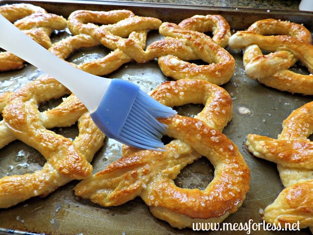 brushing butter on pretzels