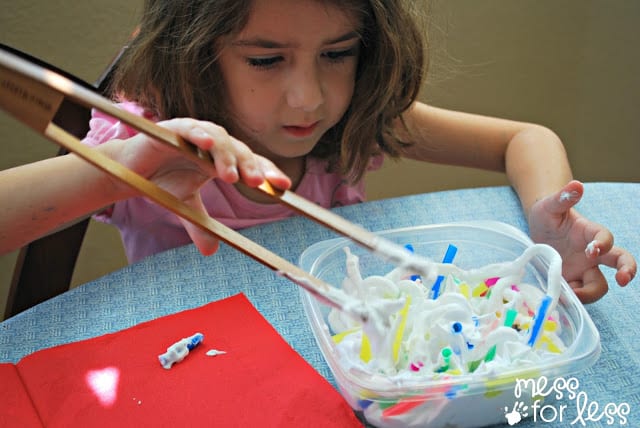 child playing with straws in shaving cream