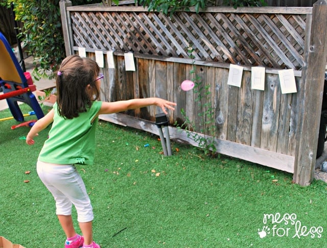 child throwing water balloon