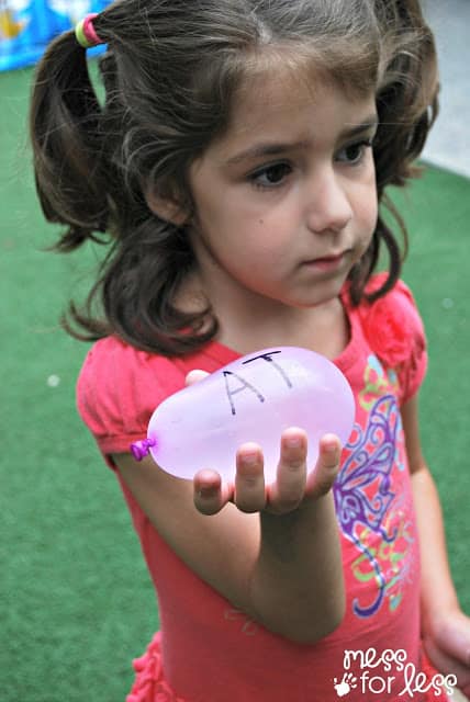 child with water balloon