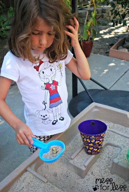 child sifting sand