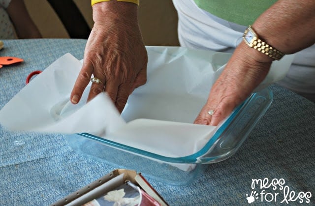 placing parchment paper in a pan