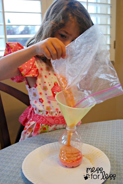 pouring sand into a funnel